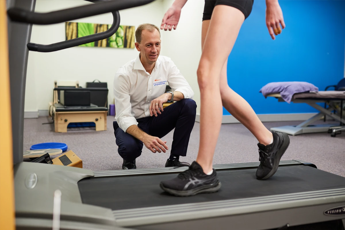Kent Sweeting, podiatrist of Performance Podiatry assessing a patient on a treadmill
