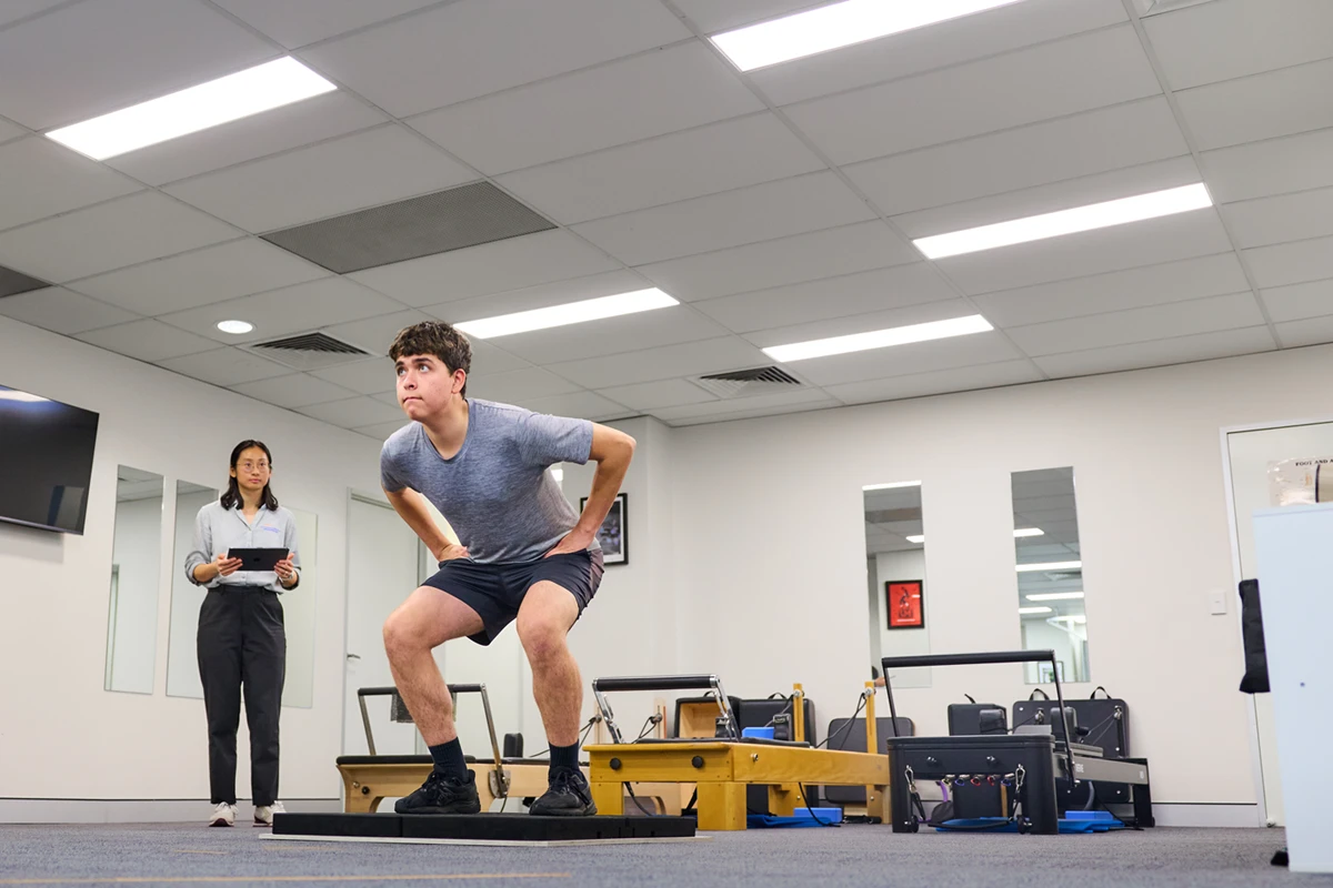 Runner about to jump in a VALD jump testing (ForceDecks) at Performance Podiatry & Physiotherapy in Brisbane's West End.