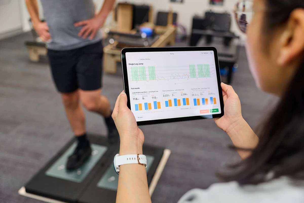Runner undergoing a VALD jump/hop testing (ForceDecks) at Performance Podiatry & Physiotherapy in Brisbane's West End.