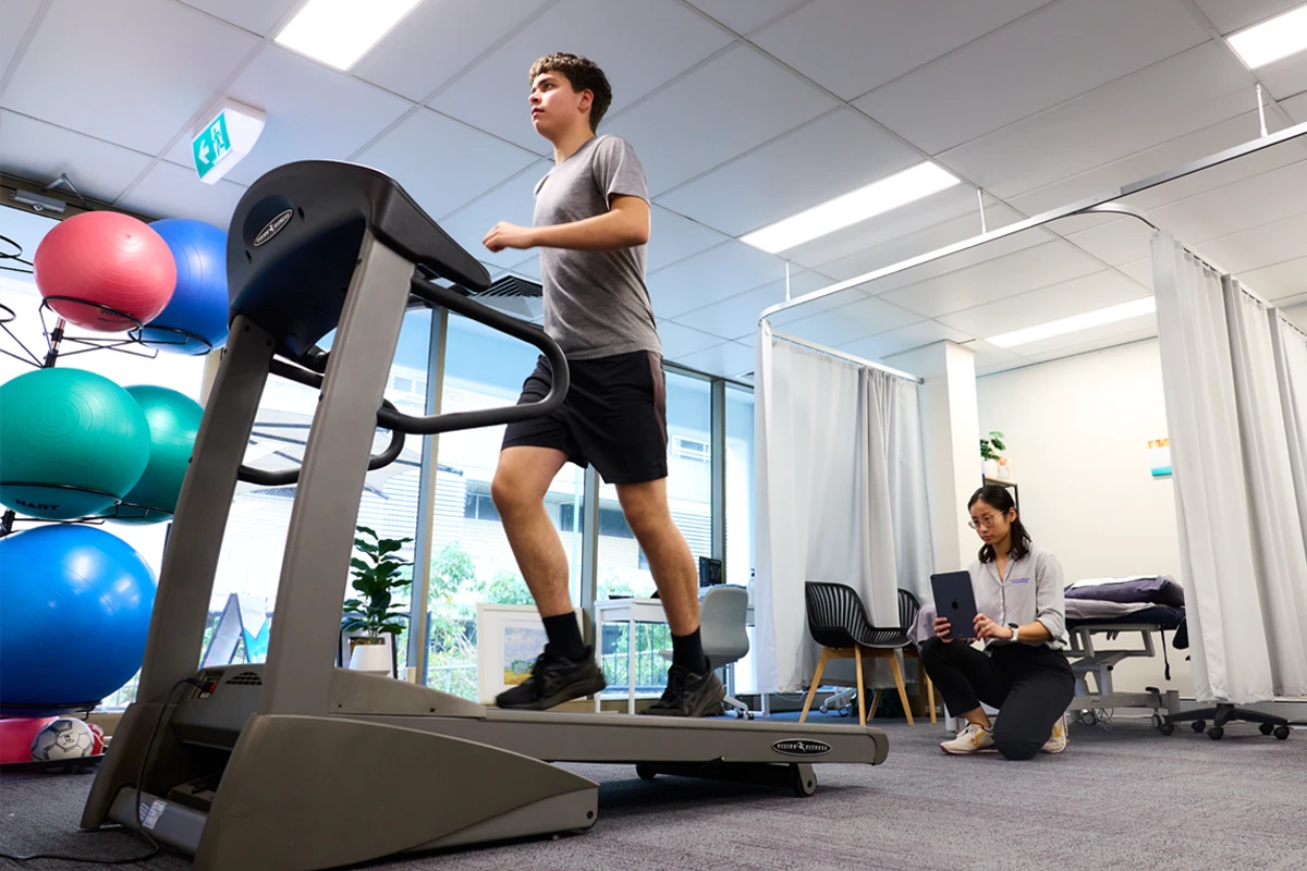 Runner undergoing a running gait assessment on a treadmill at Performance Podiatry & Physiotherapy in Brisbane's West End.